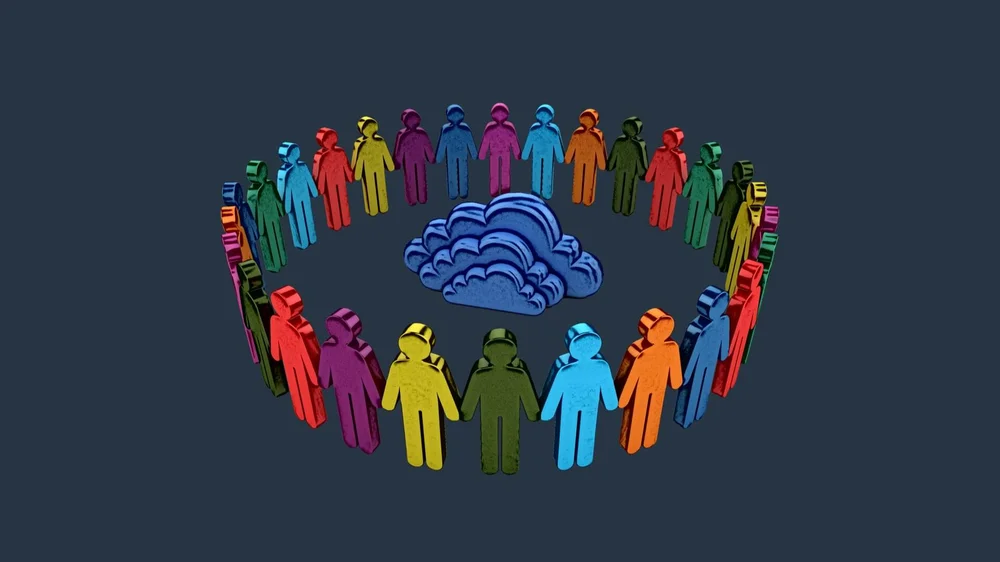 People holding hands in the circle standing around the symbol of the cloud symbolizing collaboration